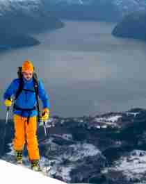Things to do: Two people skiing above Storfjorden in Stranda, Fjord Norway
