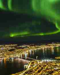 Northern lights over Tromsø city at night