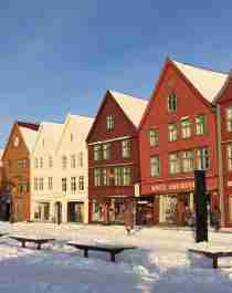 The famous harbour in Bergen with old wooden houses covered in snow, Fjord Norway