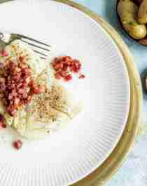A plate of lutefisk and bacon served with potatoes