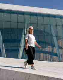Woman walking in front of the opera house in Oslo, Eastern Norway