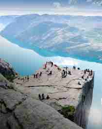 People standing on Preikestolen mountain in Lysefjorden in Fjord Norway