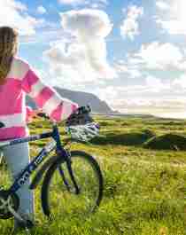 A woman biking along Norwegian Scenic Route Andøya in Vesterålen