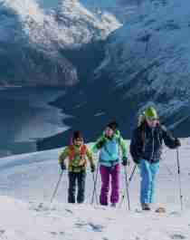 Three people ski touring at Mount Hoven in Loen in Nordfjord, Fjord Norway