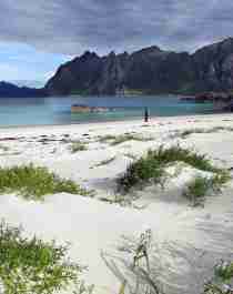 A person on the beach by the fishing village Hovden in Bø in Vesterålen, Northern Norway
