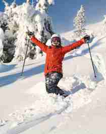 Happy female skier in powder snow in Trysil