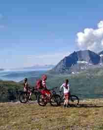 Three people mountain biking in the Lyngenfjord region, Northern Norway