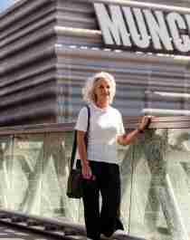 A woman walks past the MUNCH museum