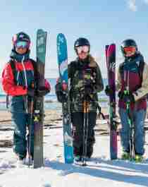 Three skiers just done mountain-to-beach-skiing in Senja