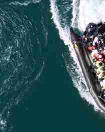 A RIB filled with people seen from above on Saltstraumen in Bodø, Northern Norway