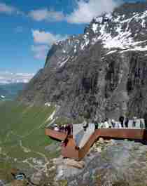 Places to go in Norway: People admiring the view of the Norwegian Scenic Route Trollstigen in Fjord Norway from Trollstigen viewpoint