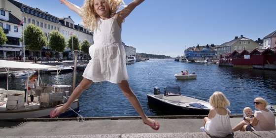 Girl jumping at Pollen harbour in Arendal