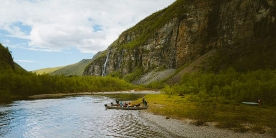 A group of people around two boats in Lyngenfjord, Northern Norway