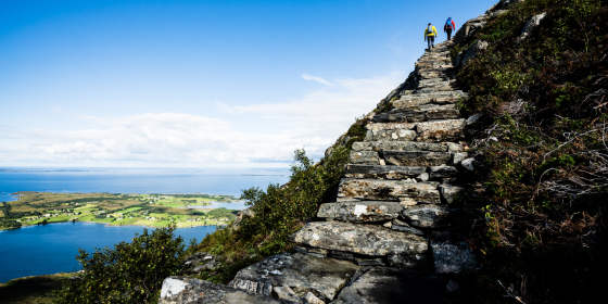 To people hiking the Midsuntrappene mountain stairway to Rørsethornet near Molde, Norway