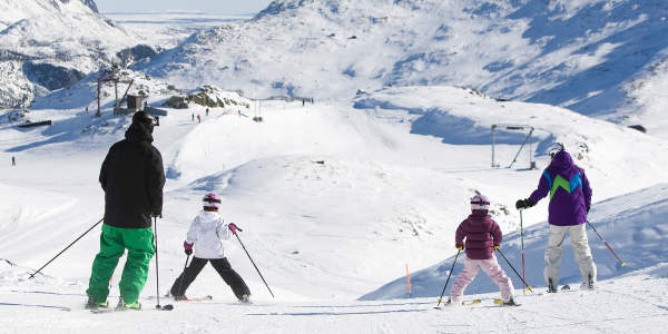 Two adults and two children alpine skiing in Hemsedal