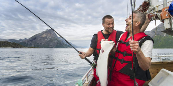 Two men in a boat sea fishing in Tromsø