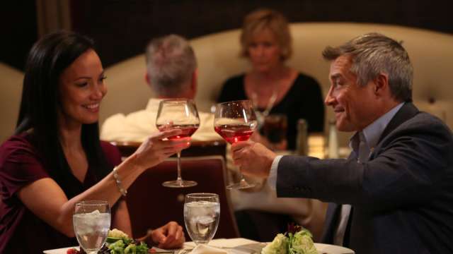 A couple enjoying a dinner and wine at Gregory’s Mesquite Grill inside Eureka Casino Resort.