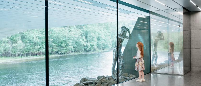 Girl looking at a silver sculpture at the Kistefos Museum in Norway