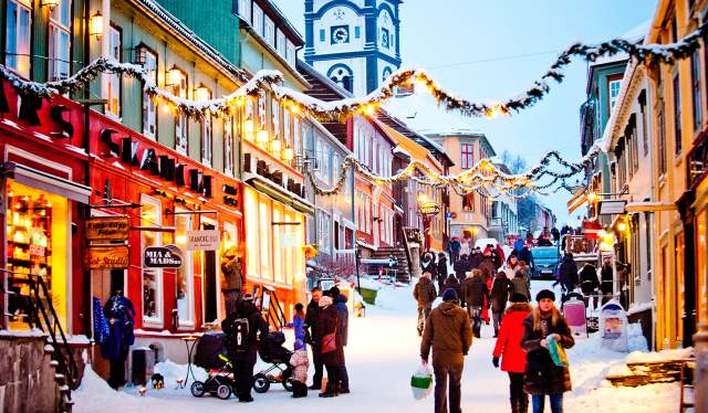 People walking in the snowy street during a Christmas market in Røros in Trøndelag, Norway