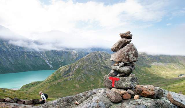 A pile of rocks with a sign on the hiking trail of the Besseggen ridge, Jotunheimen, Eastern Norway