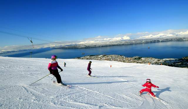 People are skiing at Narvikfjellet ski resort in Narvik, Northern Norway
