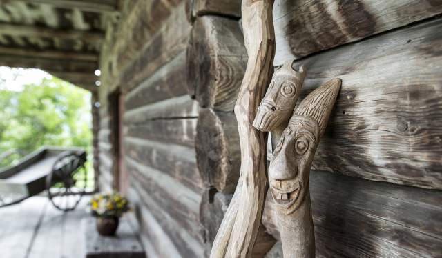 Wooden sticks with troll faces carved into them at Sygard Grytting, Gudbrandsdalen, Eastern Norway