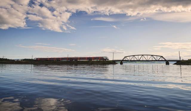 A train on the Sørlandsbanen, crossing a bridge over the water, Southern Norway