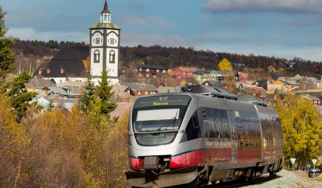 A train on the Rørosbanen with a view on the town of Røros, Trøndelag, Norway