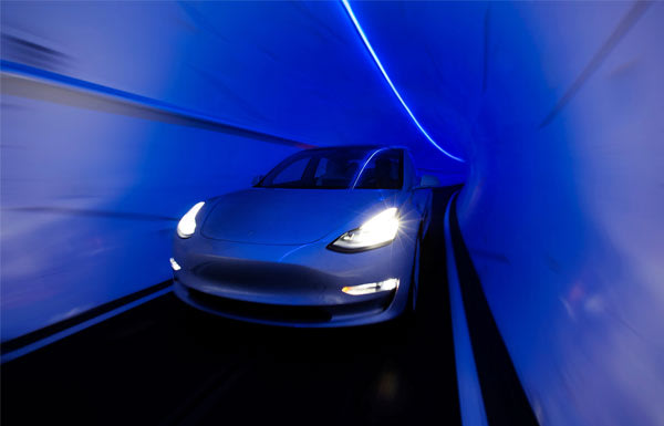 Car Driving Through Boring Tunnel
