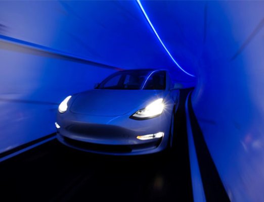 Car Driving Through Boring Tunnel