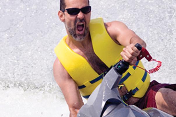 Man on a jet ski with a yellow life vest