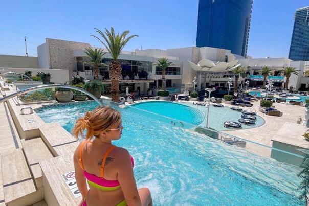 Woman looking out over the pool at Palms Casino Resort
