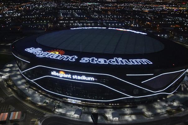 An aerial overview of Allegiant Stadium at night.
