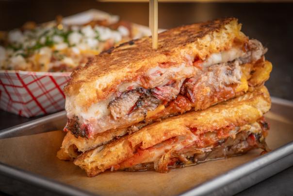 Take a bite of this delicious, ooey-gooey Briskted grilled Cheese sandwich at Mabel's Bar & Q inside of Palms Casino Resort only found in Las Vegas.