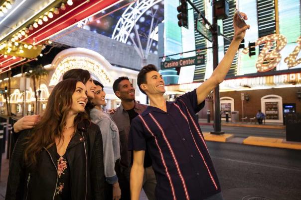 A group of friends taking a selfie together in Downtown Las Vegas. Shot by Scott Chebegia.