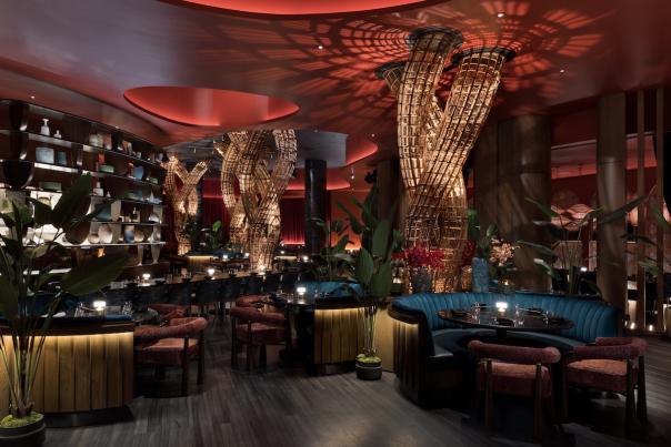 View of the interior dining area at Komodo Restaurant inside Fontainebleau Las Vegas, dimly lit and made up of earth tone colors. PHOTO CREDIT CONNIE ZHOU