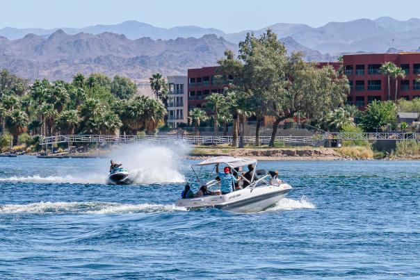 A group of people enjoying the outdoors on a boat on the Colorado River.