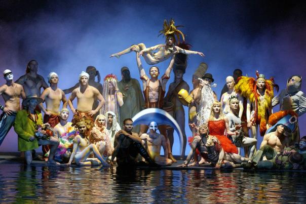 A group of performers posing on stage during the O show by Cirque du Soleil.