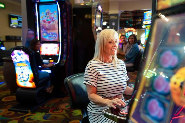 A woman having a great time playing slots at Tropicana Laughlin Hotel and Casino in Laughlin, Nevada!