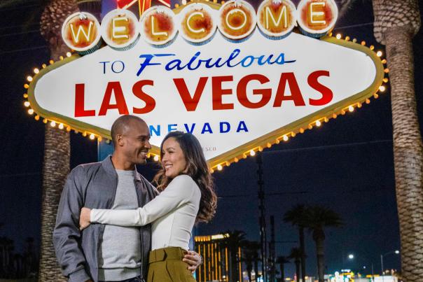 A couple posing happily in front of the famous "Welcome to Fabulous Las Vegas Sign".