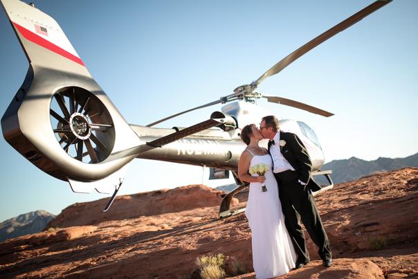Married Couple Posing in Front of a Helicopter