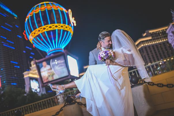 A joyful newlywed couple outside of Paris Las Vegas.