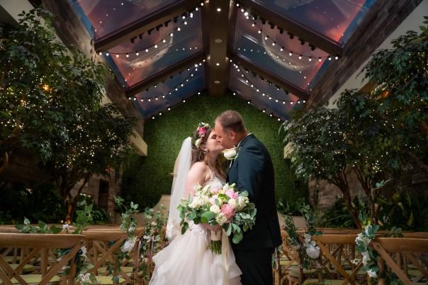 Couple kissing during wedding at the Glass Garden at Chapel of the Flowers