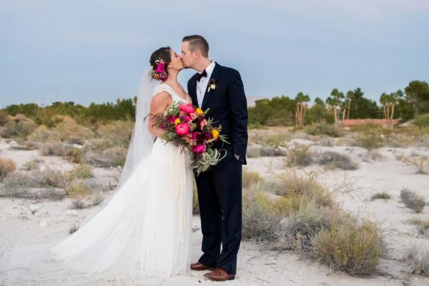Bride and Groom kissing in the desert landscape