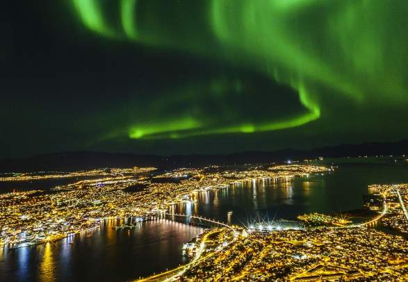 Northern lights over Tromsø city at night