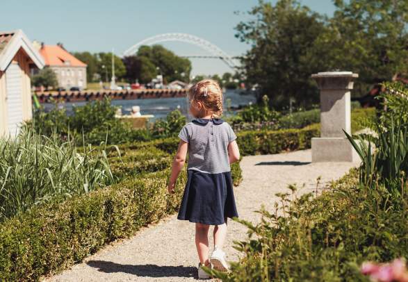 A girl walking in a garden on the island Isegran in Fredrikstad, Eastern Norway