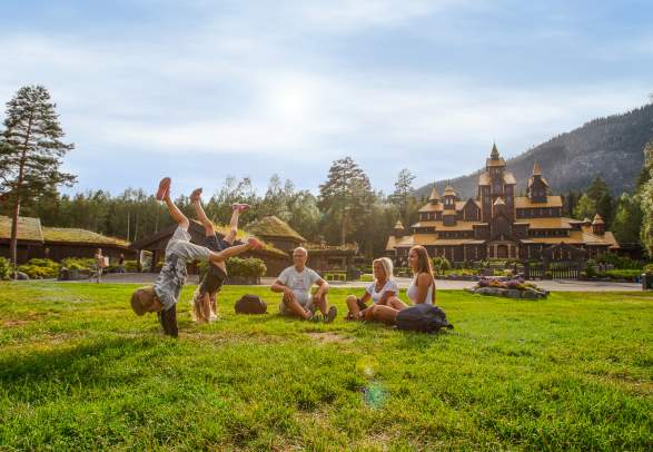 A family is having fun in front of the Fairy Tale Castle in Hunderfossen family park in Lillehammer, Eastern Norway
