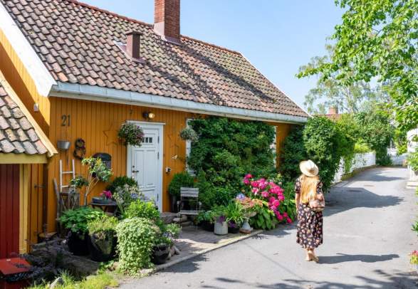 Woman walking in Badehusgata in Drøbak on a summerday, Follo