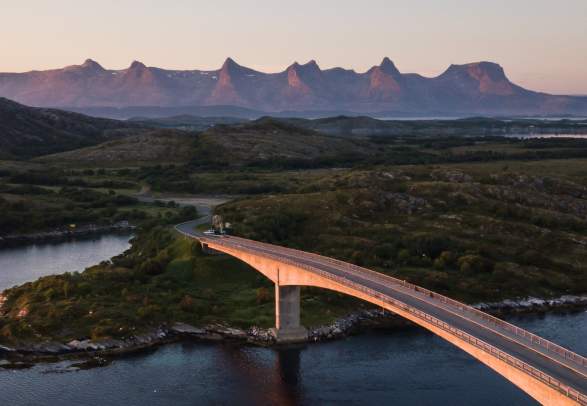A bridge connecting Herøy to another island in Helegeland, Northern Norway. In the background, the mountain range The seven sisters.