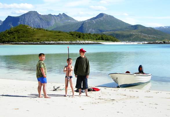 Three kids on a beach at Senja, Northern Norway